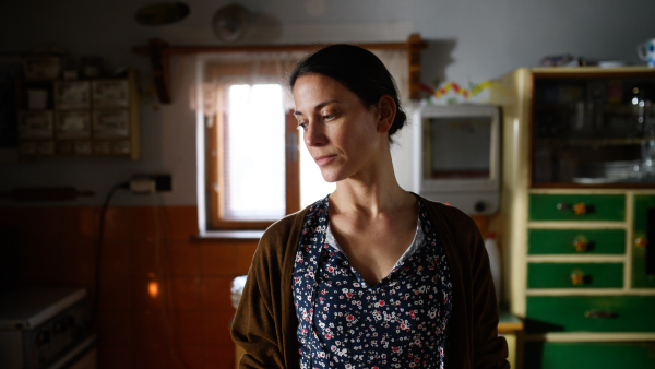 Portrait of sad poor mature woman indoors at home, poverty concept.