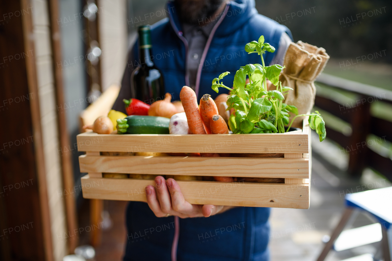 Unrecognizable courier delivering fresh fruit and vegetables groceries shopping, corona virus and quarantine concept.