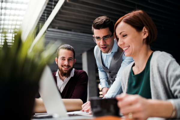 A group of young businesspeople working together in office, talking.