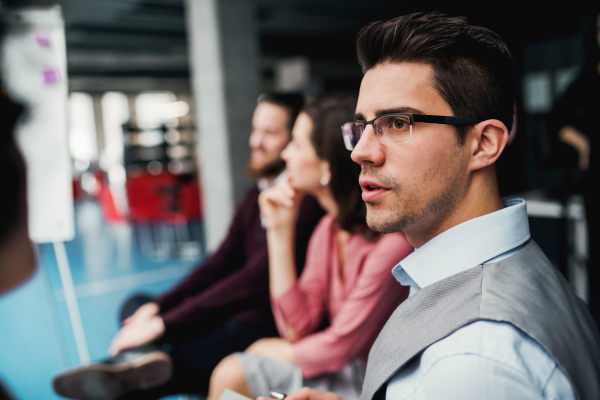 A group of young businesspeople sitting in office.