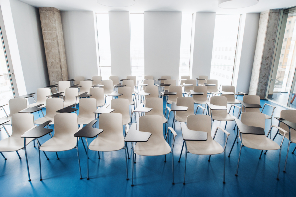 An interior of a modern spacious study room for students in a library or office.