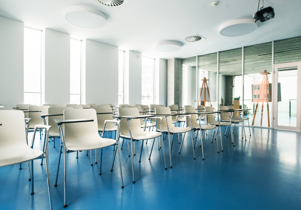 An interior of a modern spacious study room for students in a library or office.