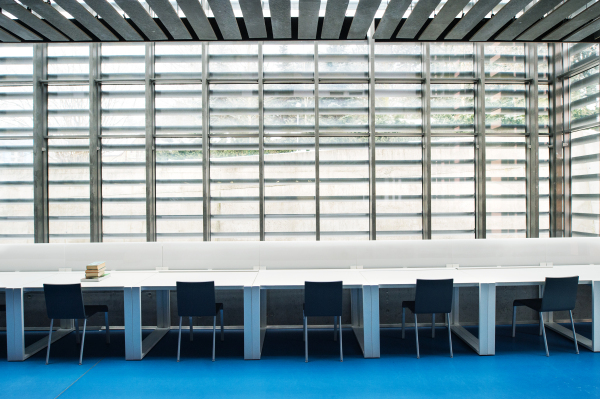 An interior of a modern spacious study room for students in a library or office.