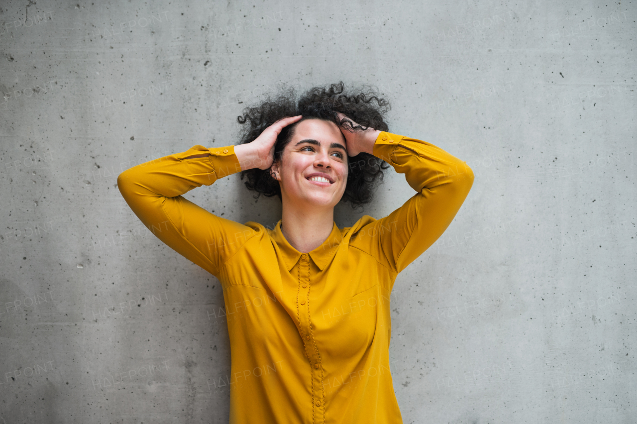 A portrait of a young student or businesswoman standing in room in a library or office.