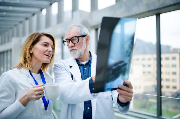 Group of doctors looking at X-ray on medical conference, discussing issues.