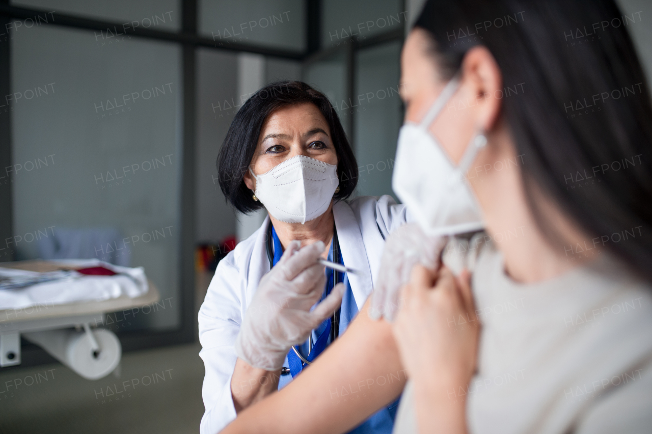 Mid woman getting vaccinated in hospital, coronavirus and vaccination concept.