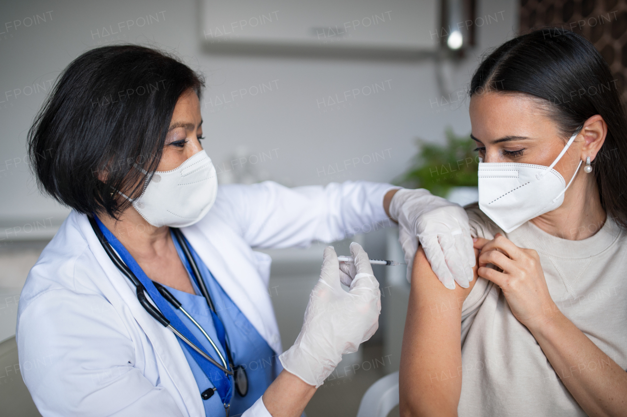 Mid woman getting vaccinated in hospital, coronavirus and vaccination concept.