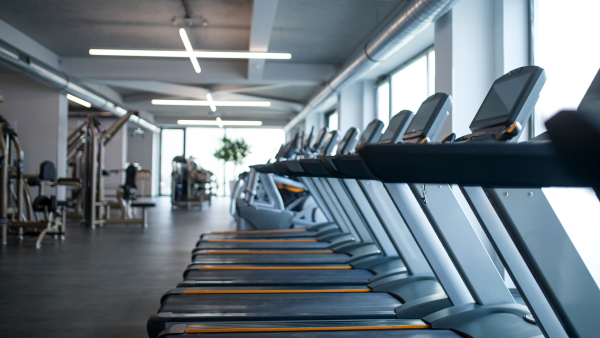 Treadmill machinesin a row in gym, safe distance and coronavirus concept.