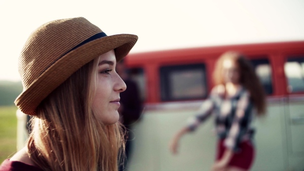 Young girl with friends on a roadtrip through countryside, dancing. Slow motion.