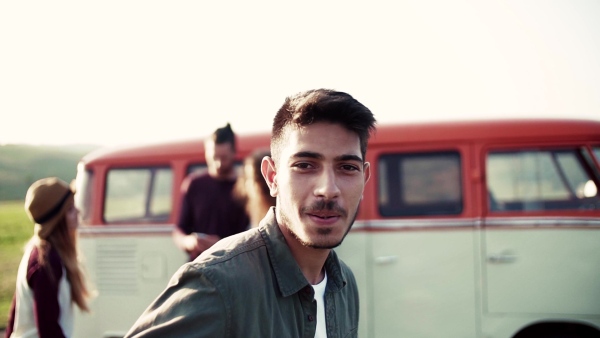 Young boy with friends on a roadtrip through countryside, dancing. Slow motion.