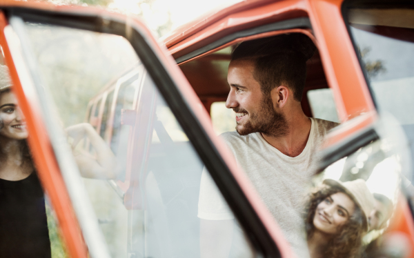 A happy young couple on a roadtrip through countryside.