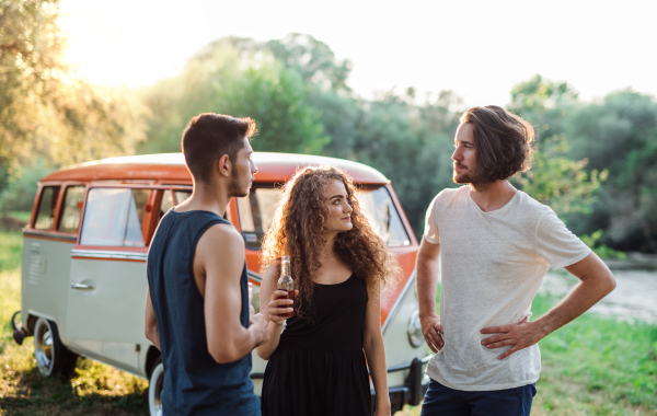 Two boys quarreling over a beautiful young girl on a roadtrip through countryside.