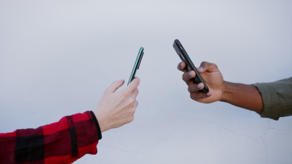 A close up of teenagers using smartphones. Social networks concept.