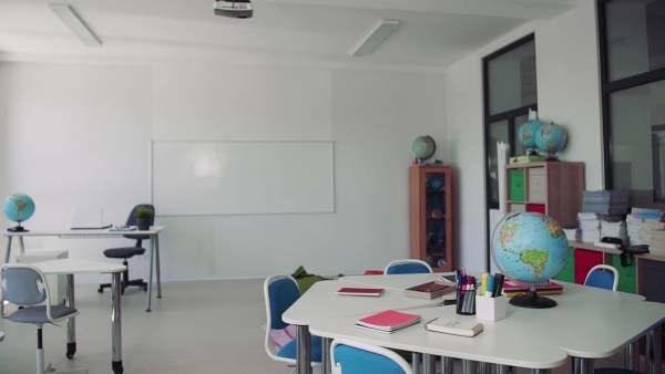 A globe on the desk in unconventional classoom in private school.