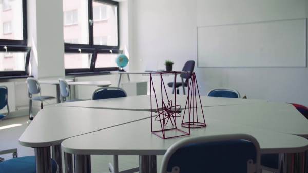 Desks with props in a classroom in private school, unconventional learning.