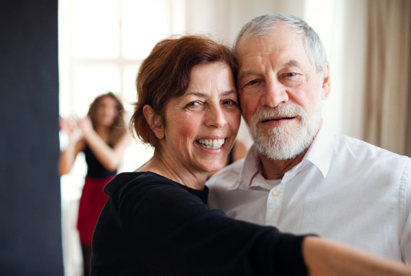 Front view portrait of senior couple atttending dancing class.