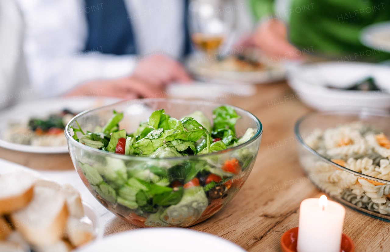 Close-up of green vegetable salad in bowl at dinner party at home.