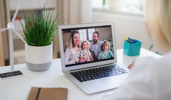 Unrecognizable senior woman with laptop indoors at home, family video call concept.