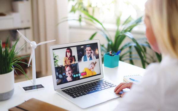 Senior businesswoman with laptop sitting indoors in home office, business call concept.