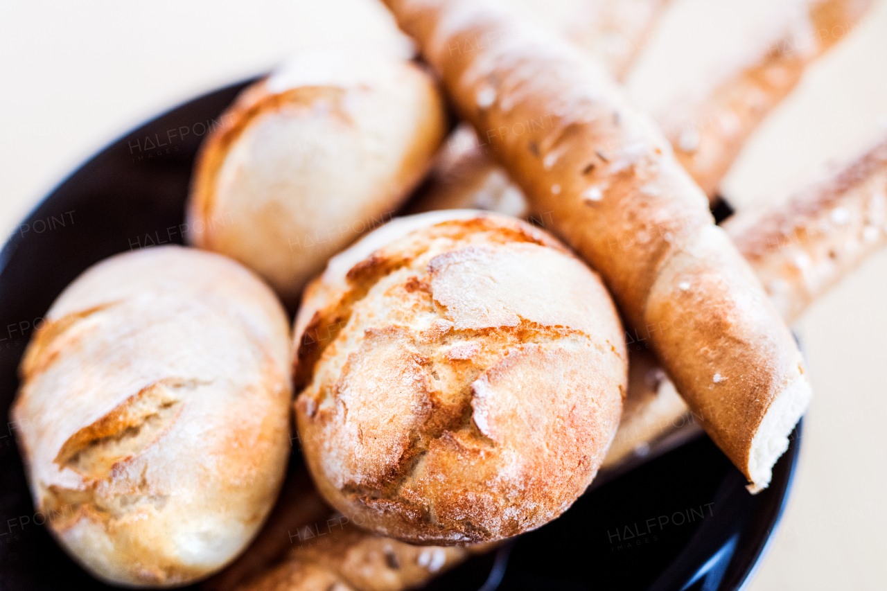 Composition of bread buns and bread sticks on the table. Close up.