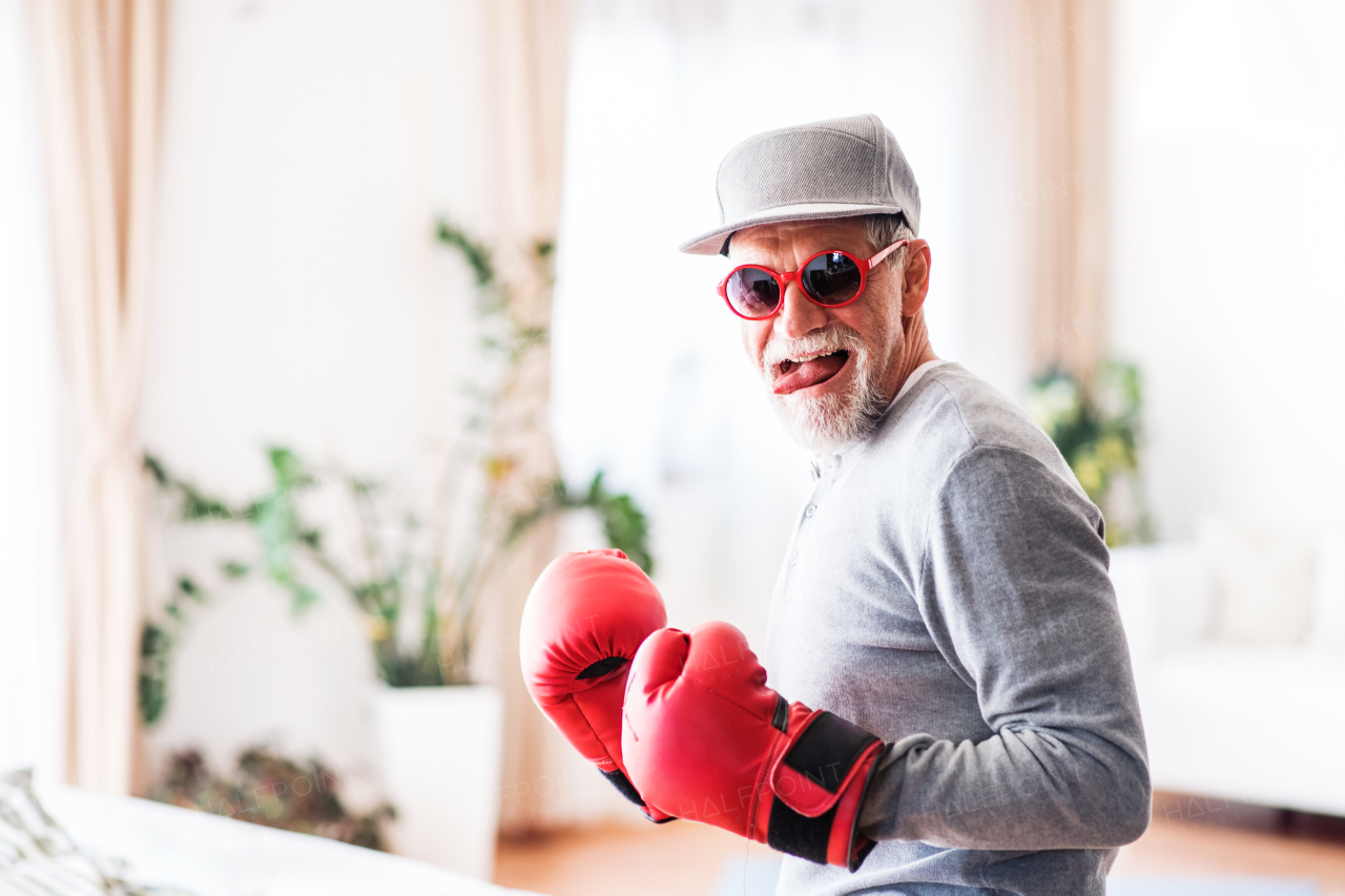 Crazy senior man having fun at home.