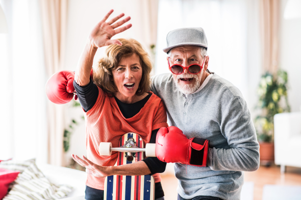 Crazy senior couple having fun at home.