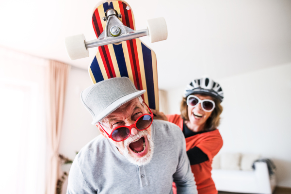 Crazy senior couple having fun at home.