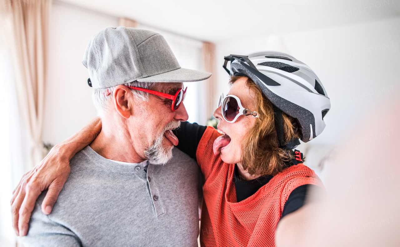 Crazy senior couple having fun at home.