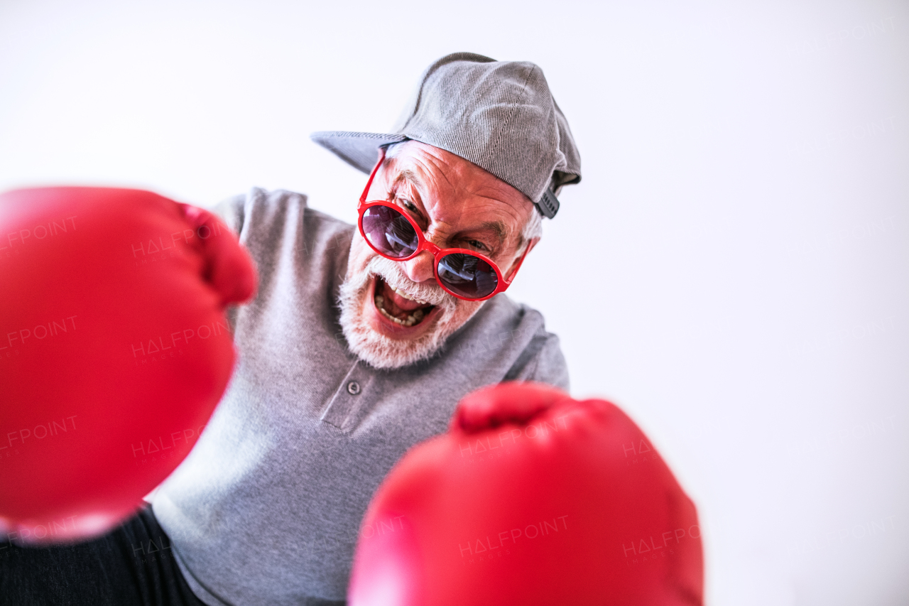 Crazy senior man having fun at home.