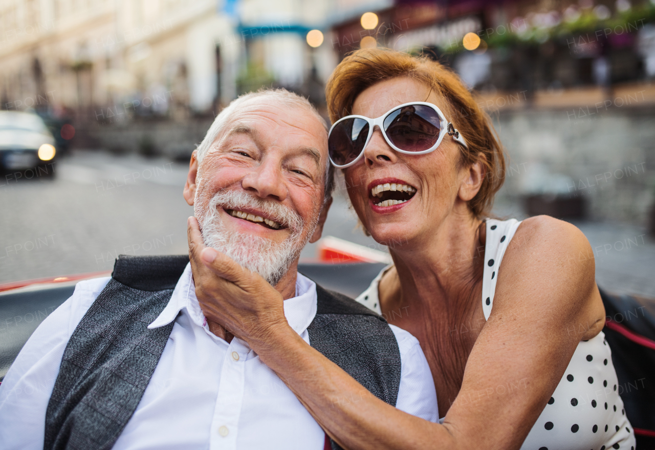 Elderly couple and vintage car on a roadtrip in city. Retired seniors enjoying free time and retirement.