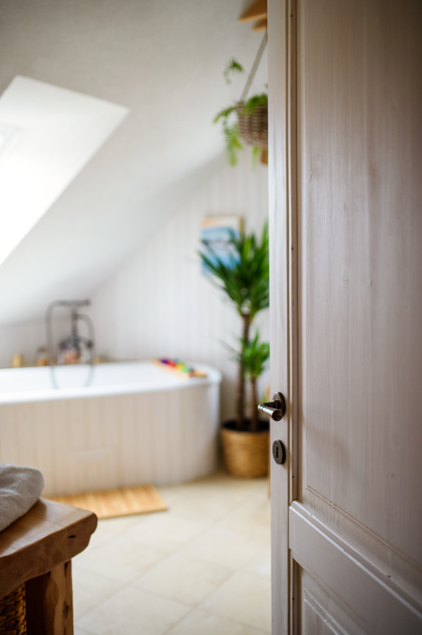 Interior of cosy white vintage bathroom at home, door open.