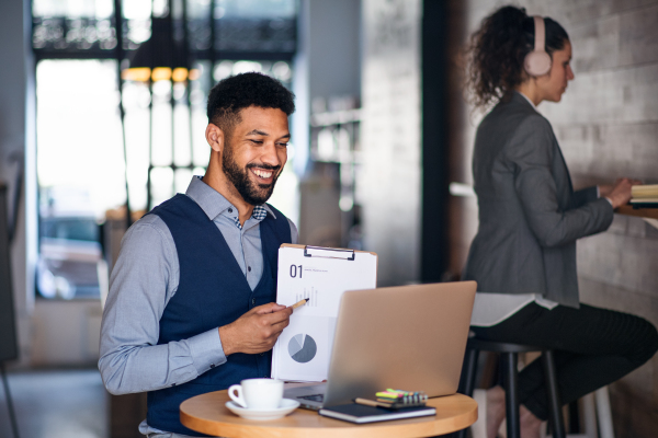 Business people with laptop working in a cafe, freelance work and video call concept.