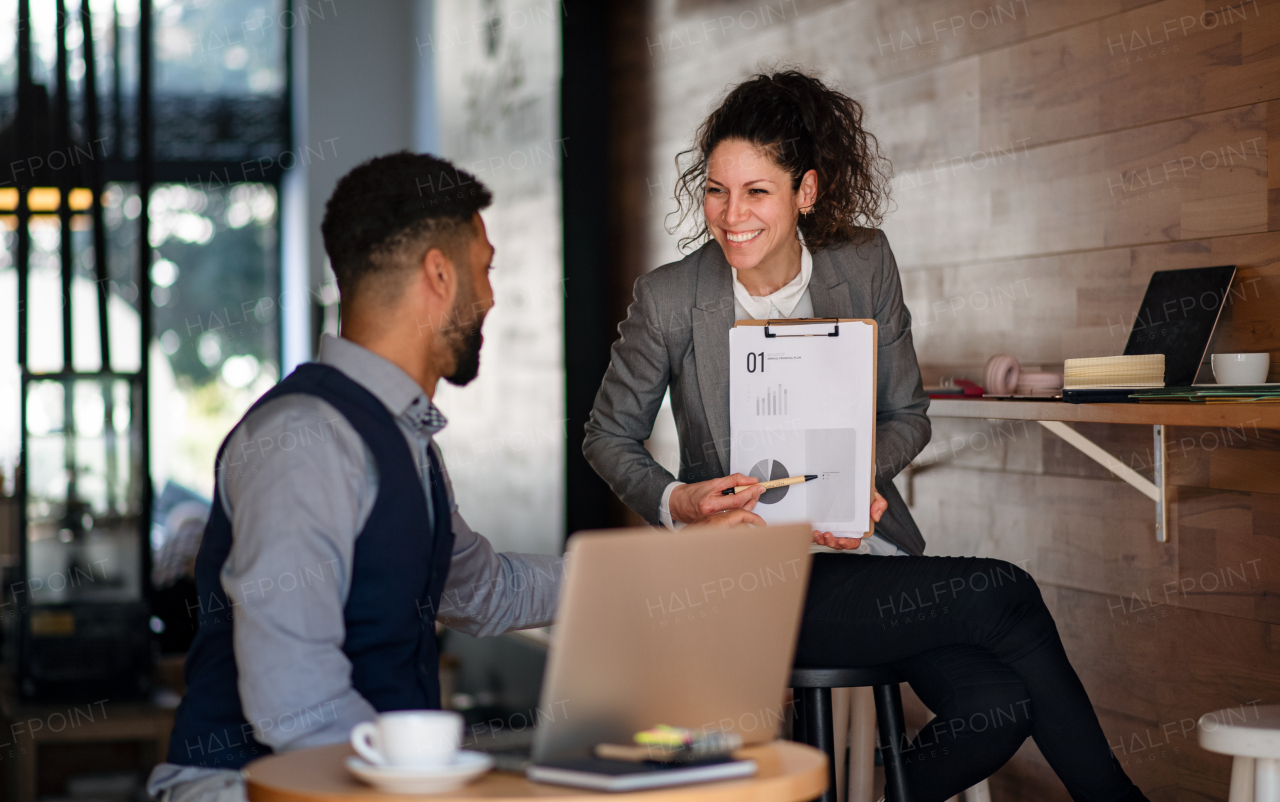 Business people with a laptop working in cafe, freelance work and presentation concept.