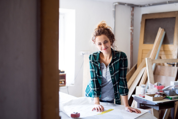 Small business of a young woman. Beautiful young woman worker in workroom.