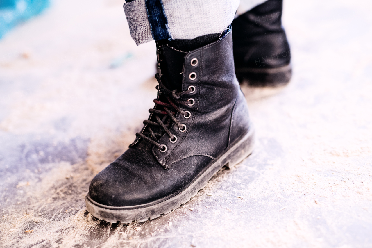 Small business of a young woman. Legs of an unrecognizable woman worker.