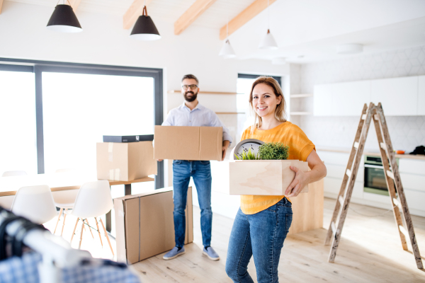 A young happy couple furnishing new house, a moving in new home concept.