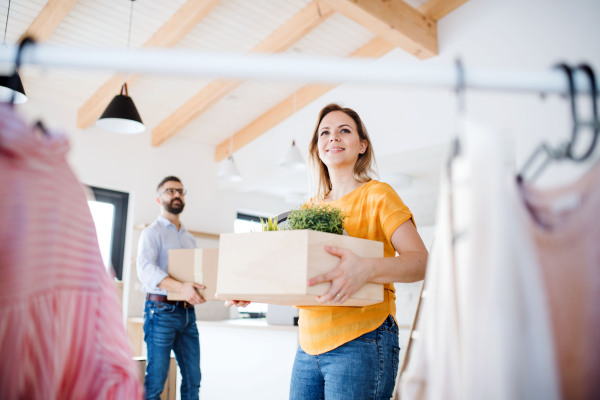 A young happy couple furnishing new house, a moving in new home concept.