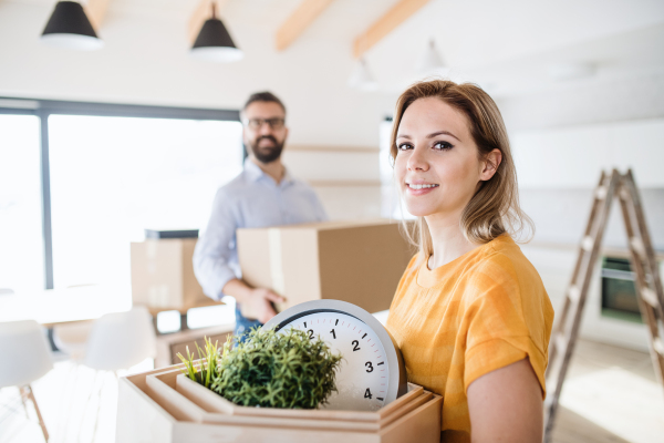 A young happy couple furnishing new house, a moving in new home concept.