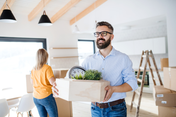 A young happy couple furnishing new house, a moving in new home concept.