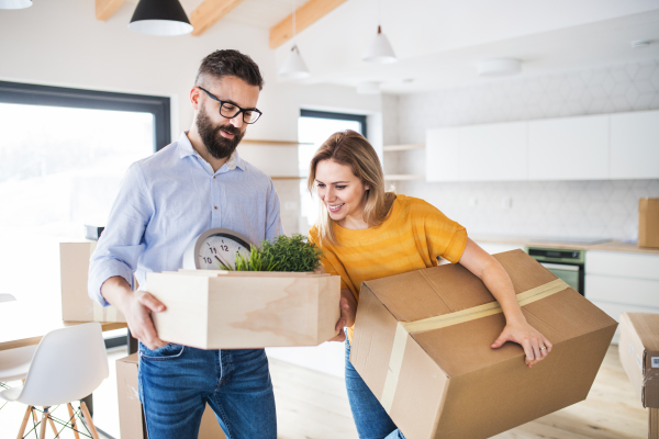 A young happy couple furnishing new house, a moving in new home concept.