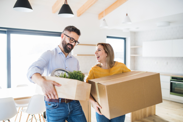 A young happy couple furnishing new house, a moving in new home concept.