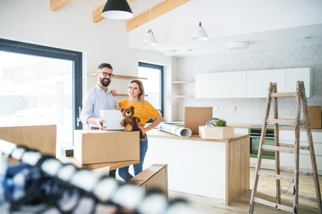 A young happy couple furnishing new house, a moving in new home concept.