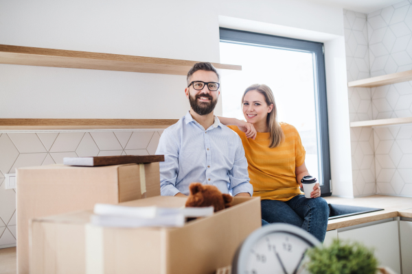 A young happy couple furnishing new house, a moving in new home concept.