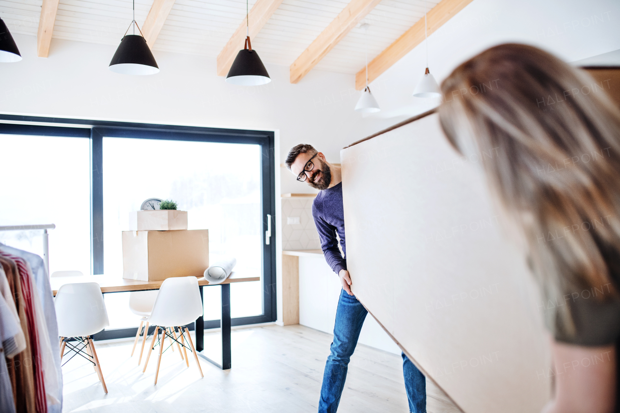 A young happy couple furnishing new house, a moving in new home concept.