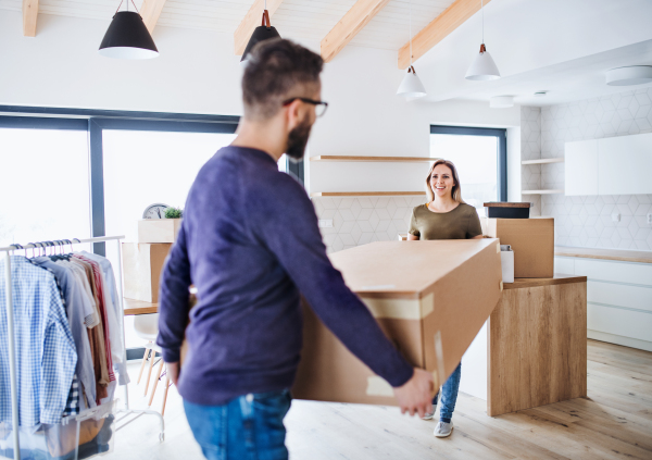 A young happy couple furnishing new house, a moving in new home concept.