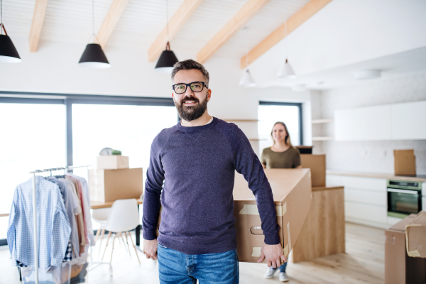 A young happy couple furnishing new house, a moving in new home concept.