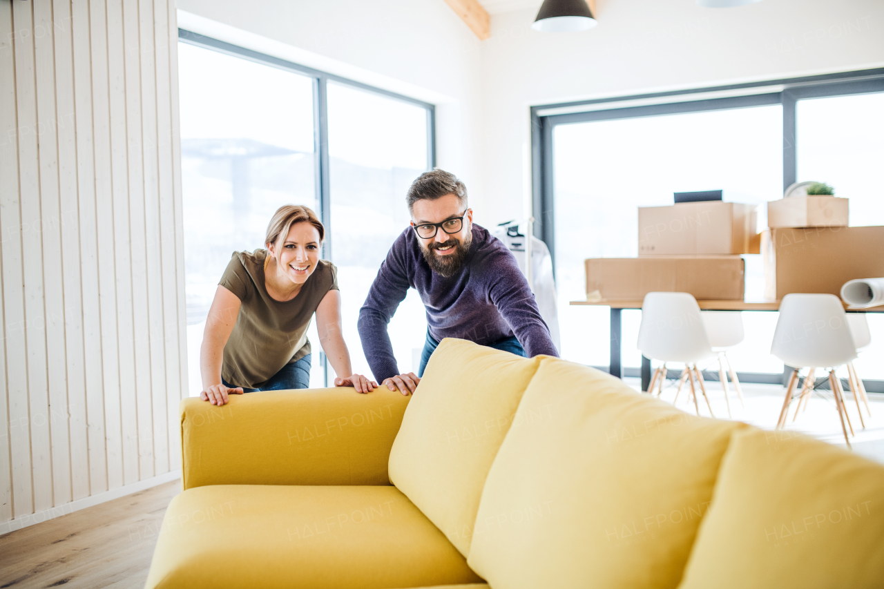 A young happy couple furnishing new house, a moving in new home concept.