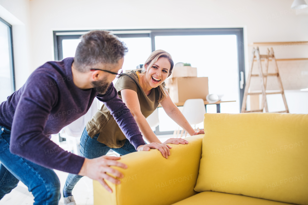 A young happy couple furnishing new house, a moving in new home concept.