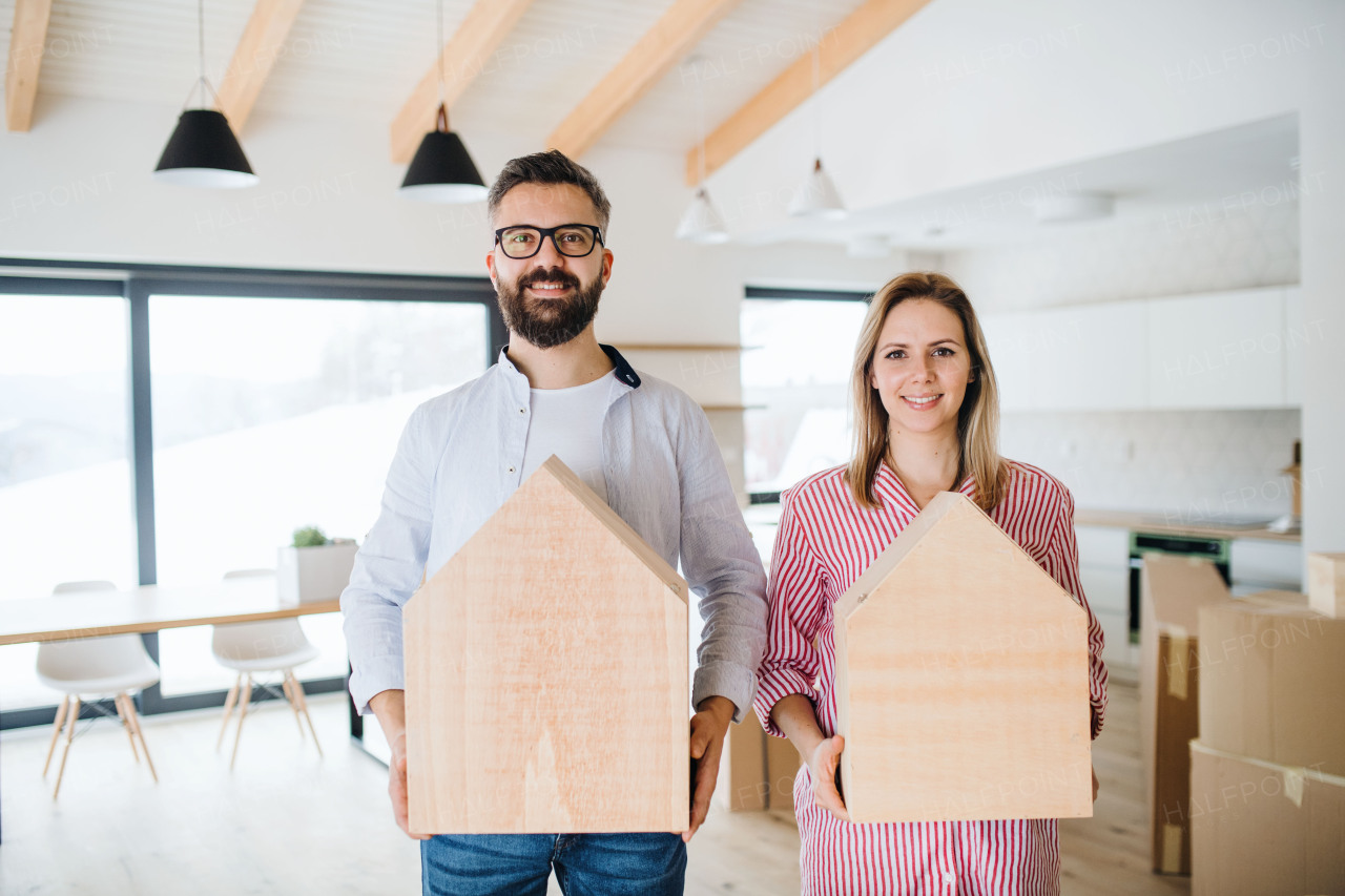 A young happy couple furnishing new house, a moving in new home concept.