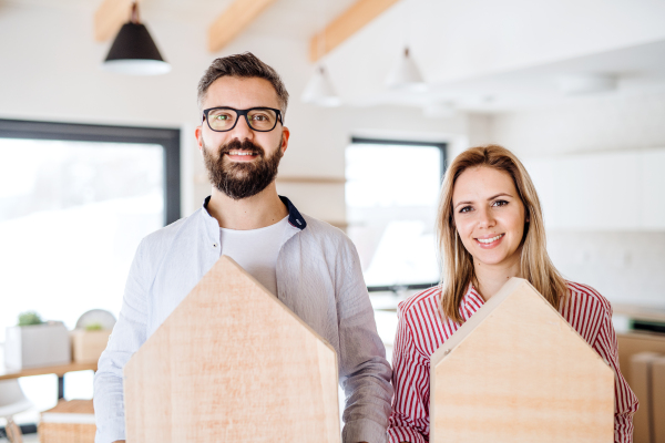 A young happy couple furnishing new house, a moving in new home concept.